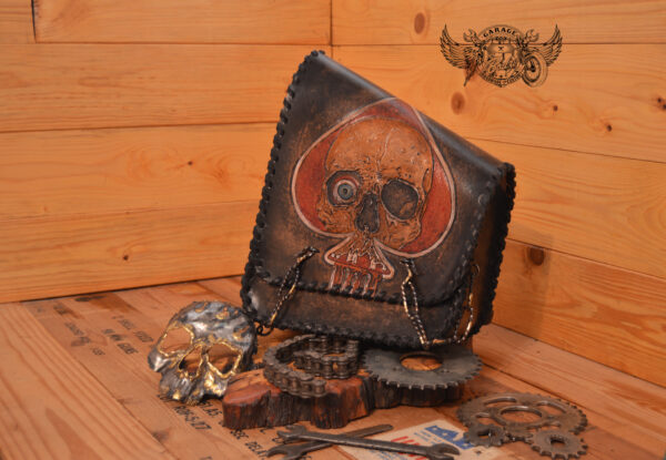 Leather motorcycle swingarm bag with hand painted ace of spades and pin up model with leather lacing and steel chains.