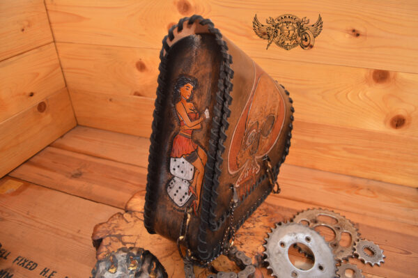 Leather motorcycle swingarm bag with hand painted ace of spades and pin up model with leather lacing and steel chains.