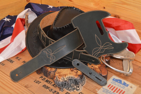 Dark green leather guitar strap and telecaster pickguard in set with padding and decorative stitching.