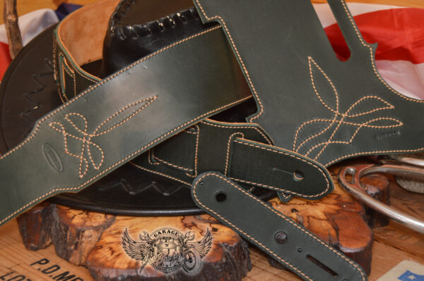 Dark green leather guitar strap and telecaster pickguard in set with padding and decorative stitching.